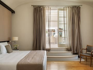 a bedroom with a bed and a chair