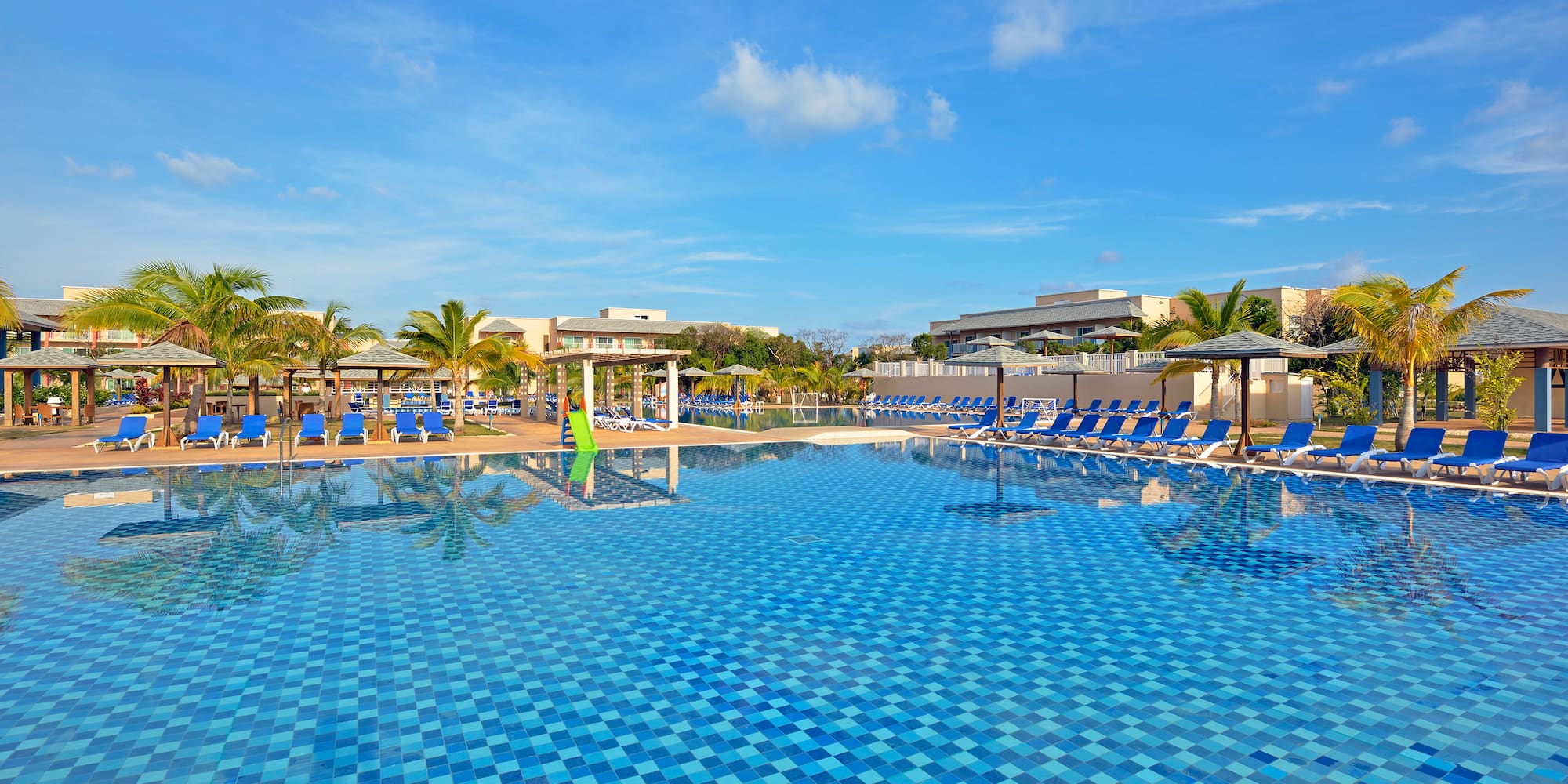 a pool with chairs and trees