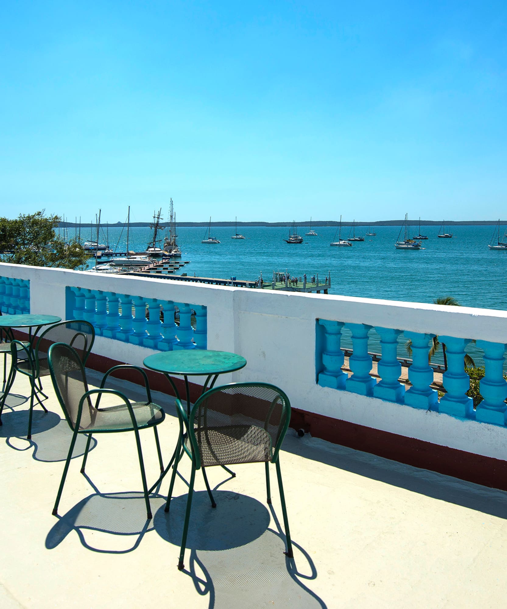 a table and chairs on a deck overlooking a body of water
