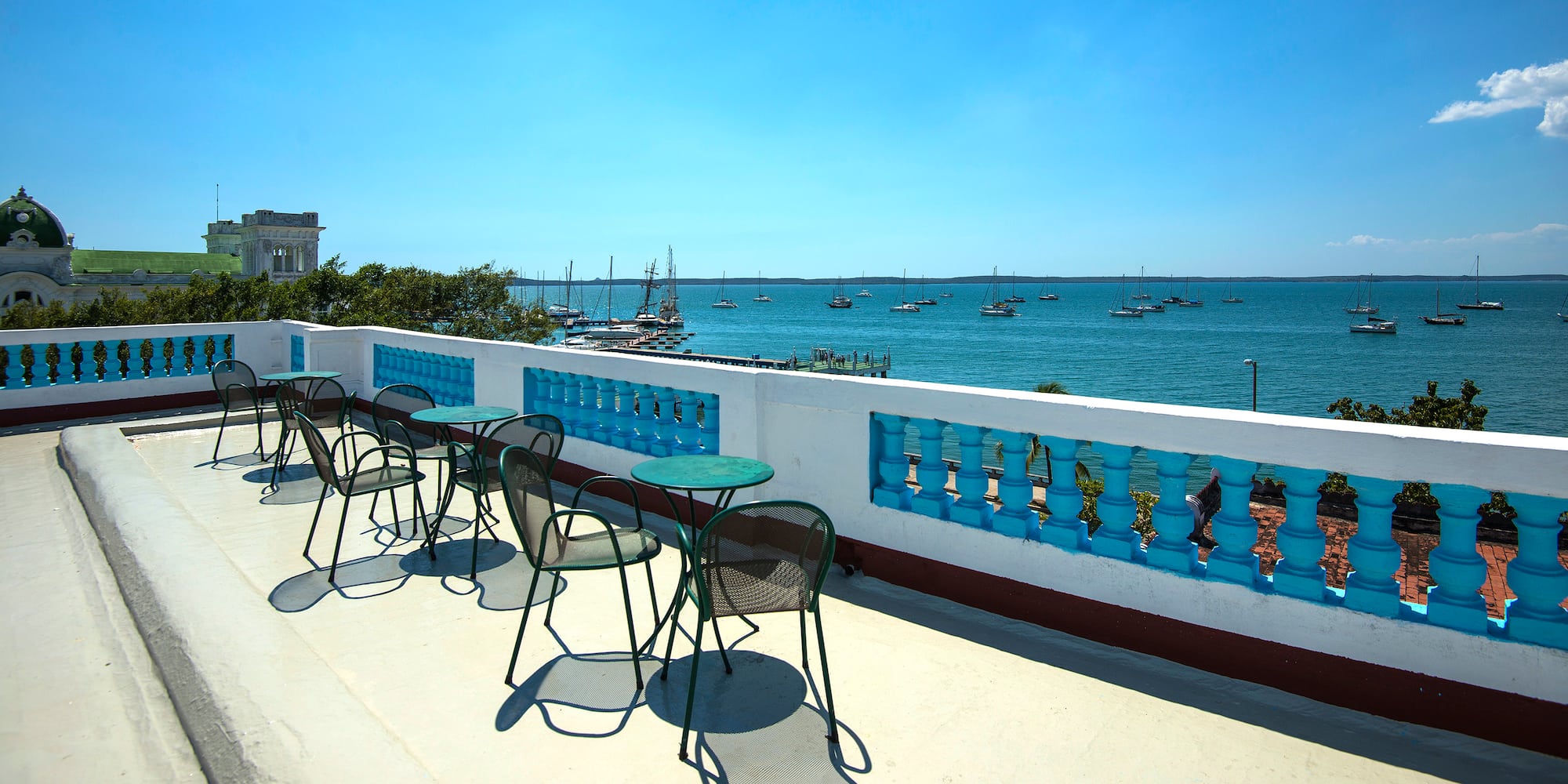 a table and chairs on a deck overlooking a body of water