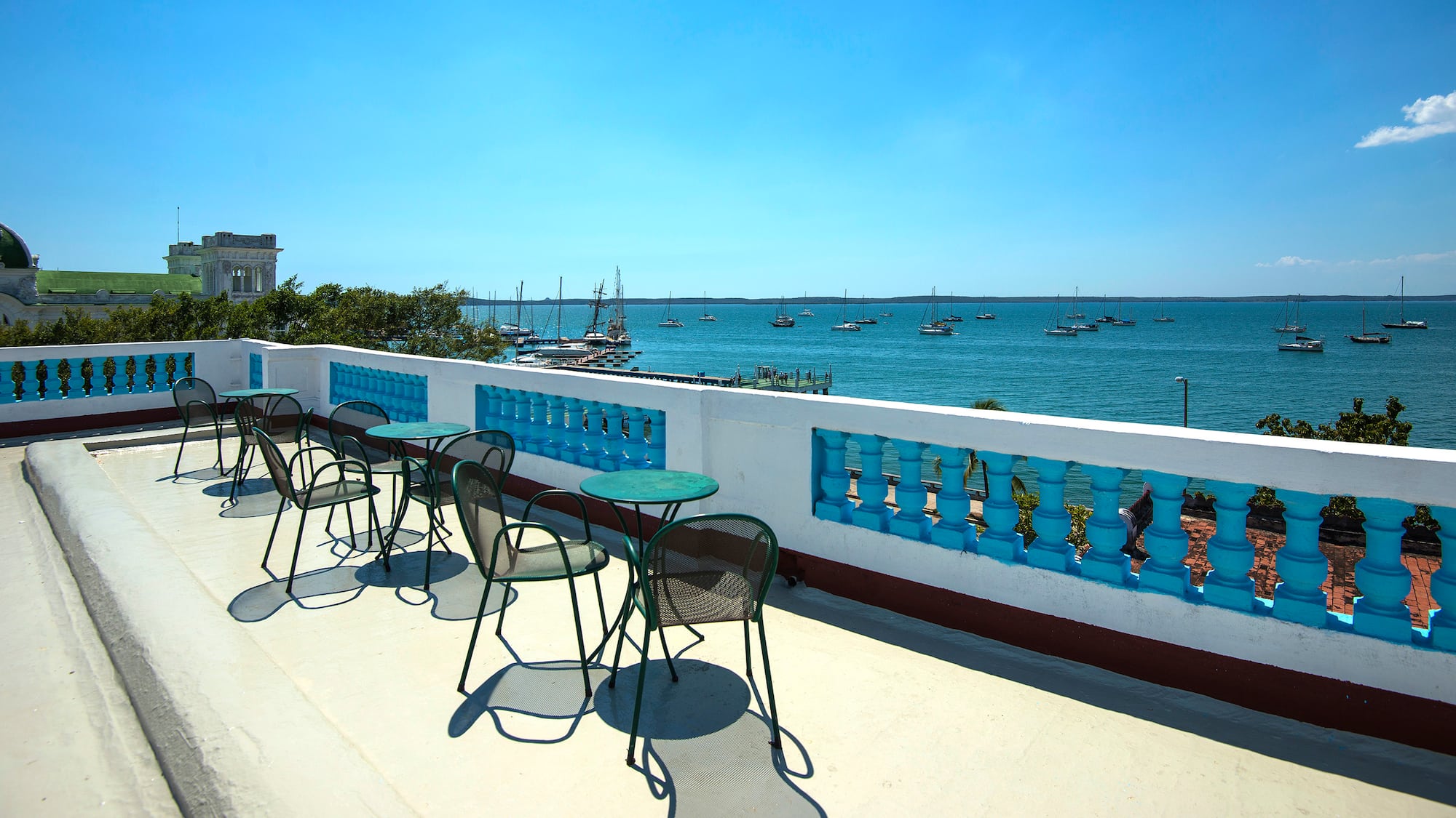a table and chairs on a deck overlooking a body of water