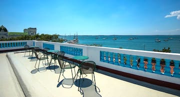 a table and chairs on a deck overlooking a body of water