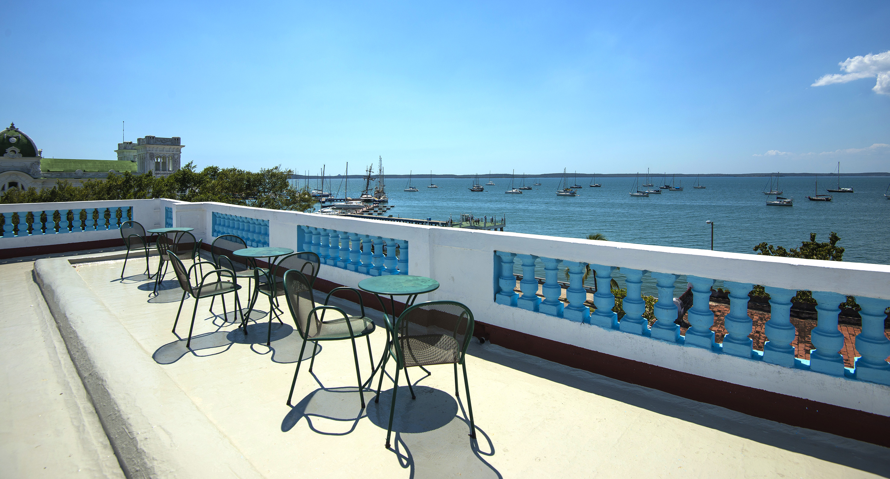 a table and chairs on a deck overlooking a body of water