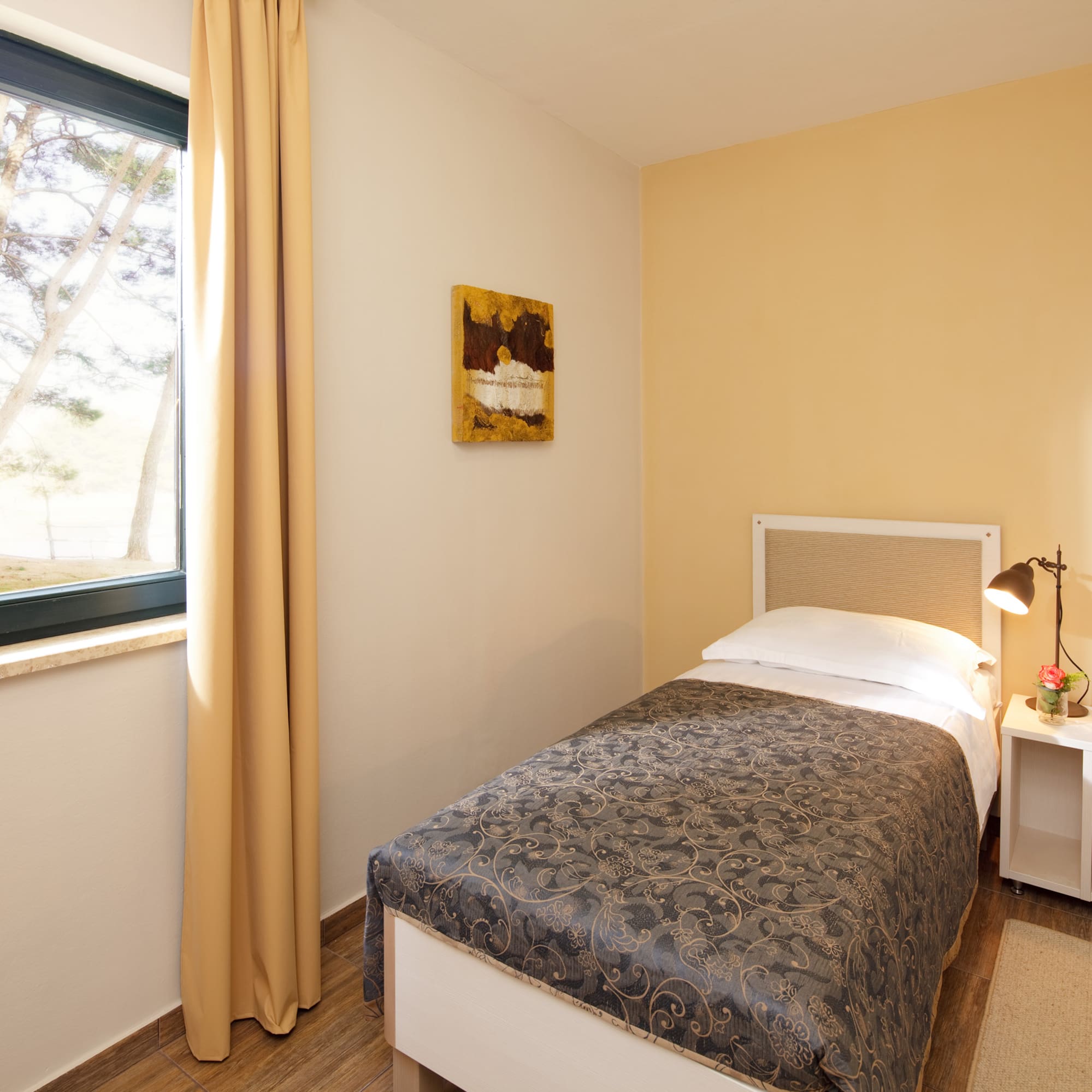 a bedroom with a bed and a lamp