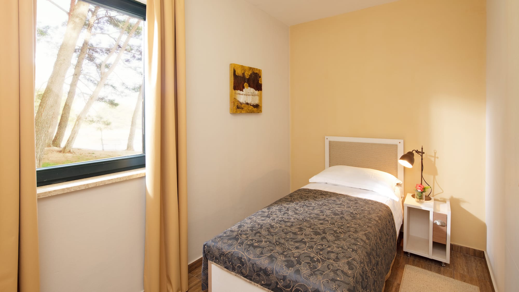 a bedroom with a bed and a lamp