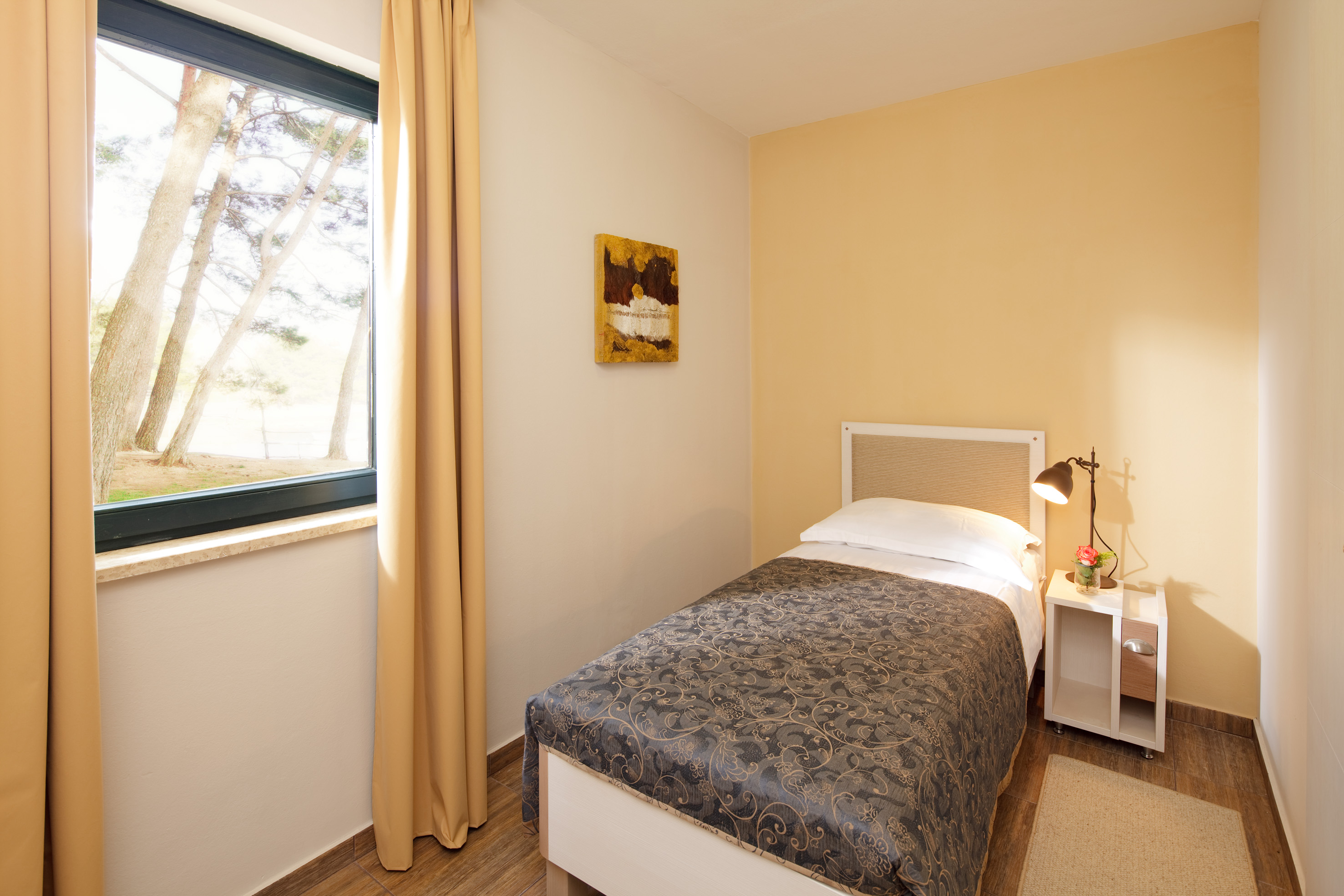 a bedroom with a bed and a lamp
