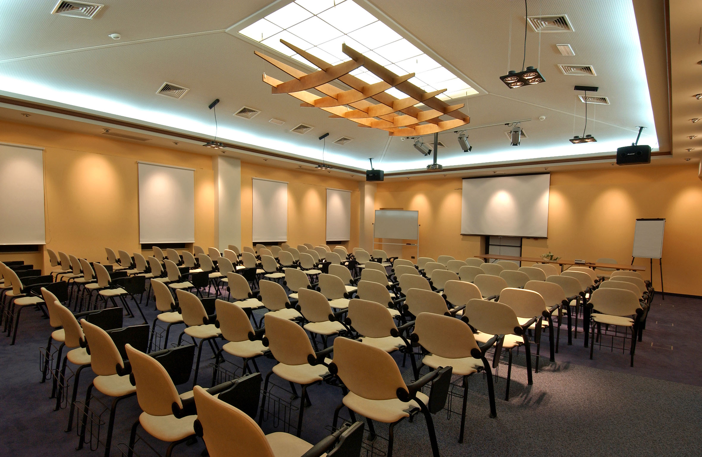a room with many chairs and a projector screen