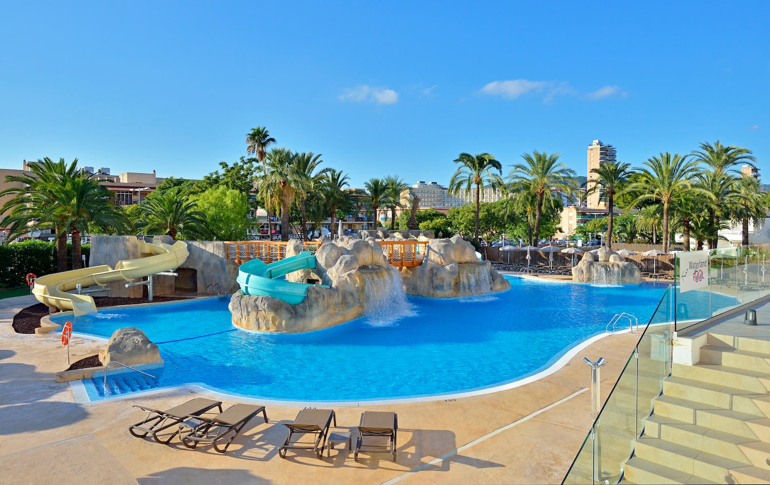 a pool with a slide and a slide