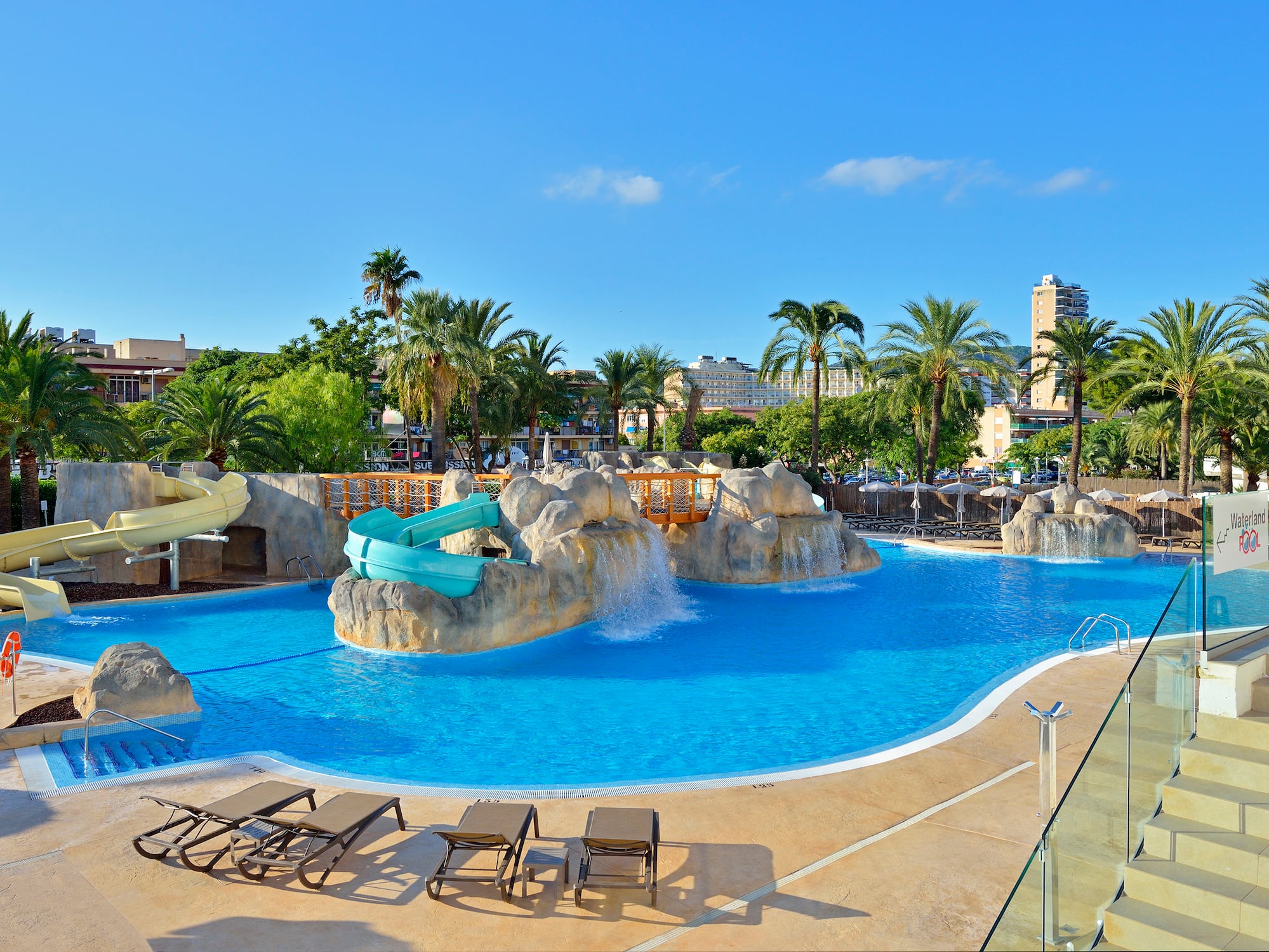 a pool with a slide and a slide
