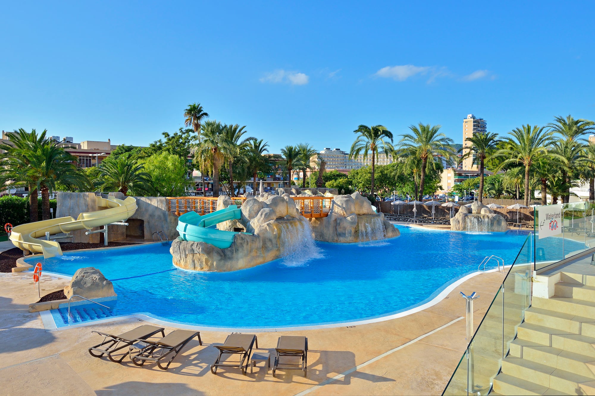 a pool with a slide and a slide