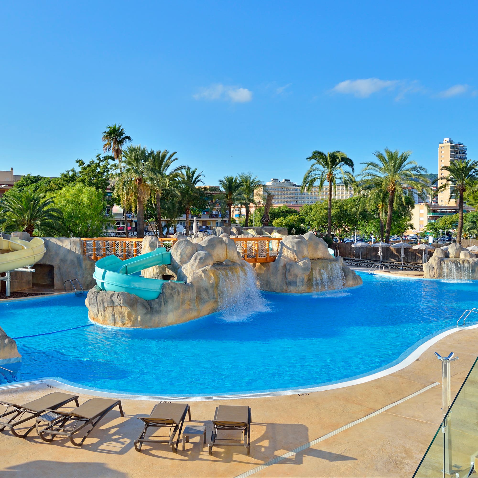 a pool with a slide and a slide