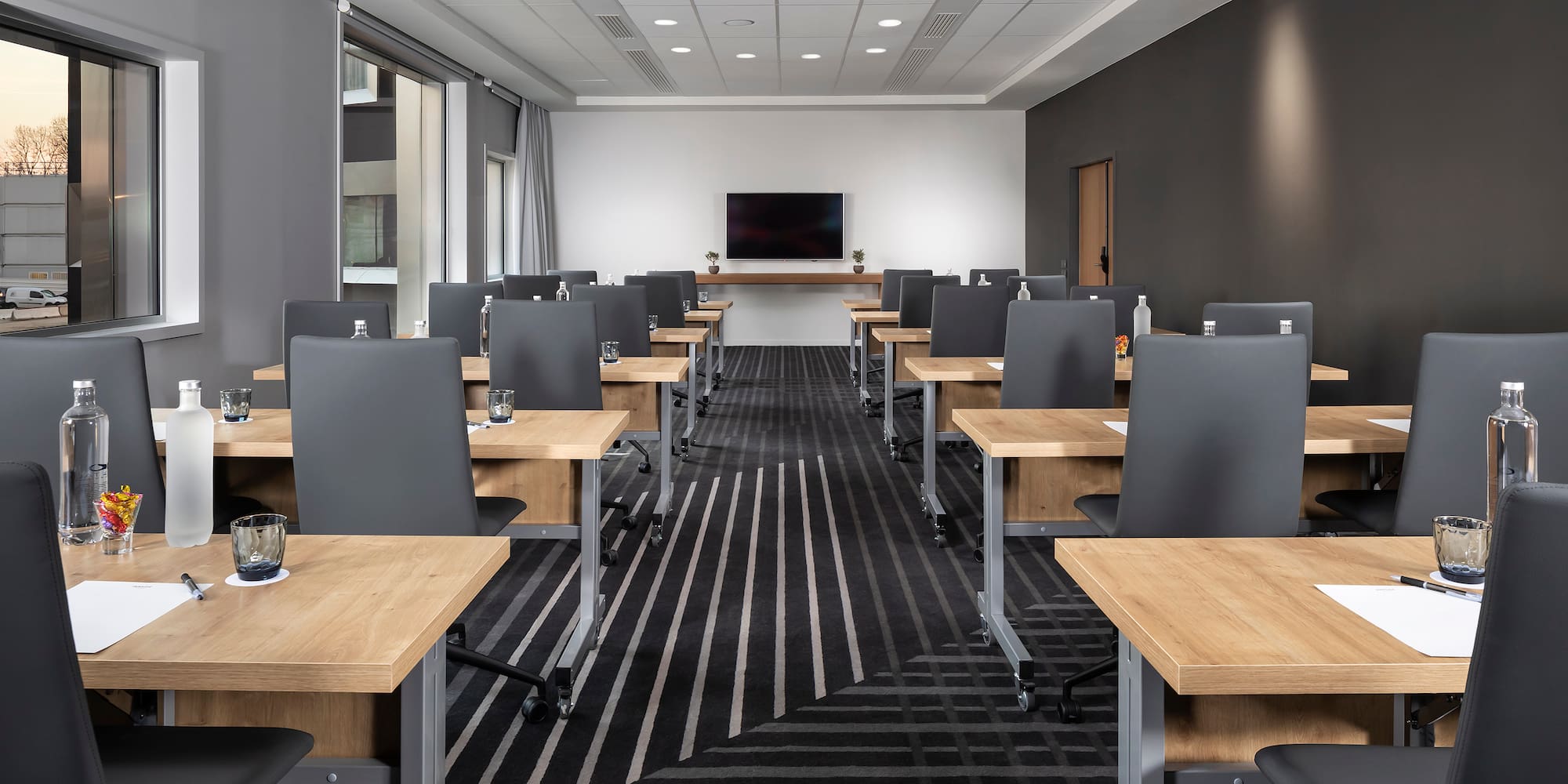 a room with black and white striped carpet and tables and chairs