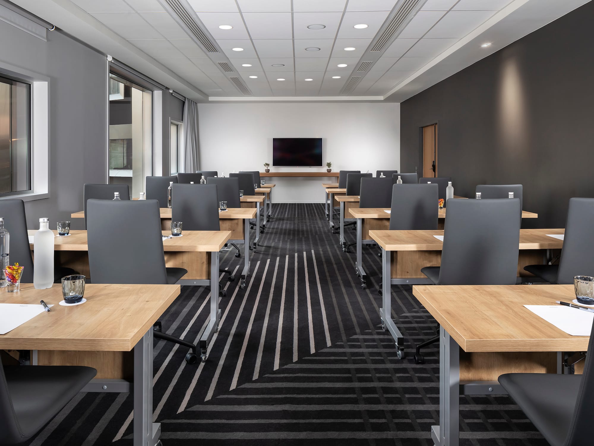 a room with black and white striped carpet and tables and chairs