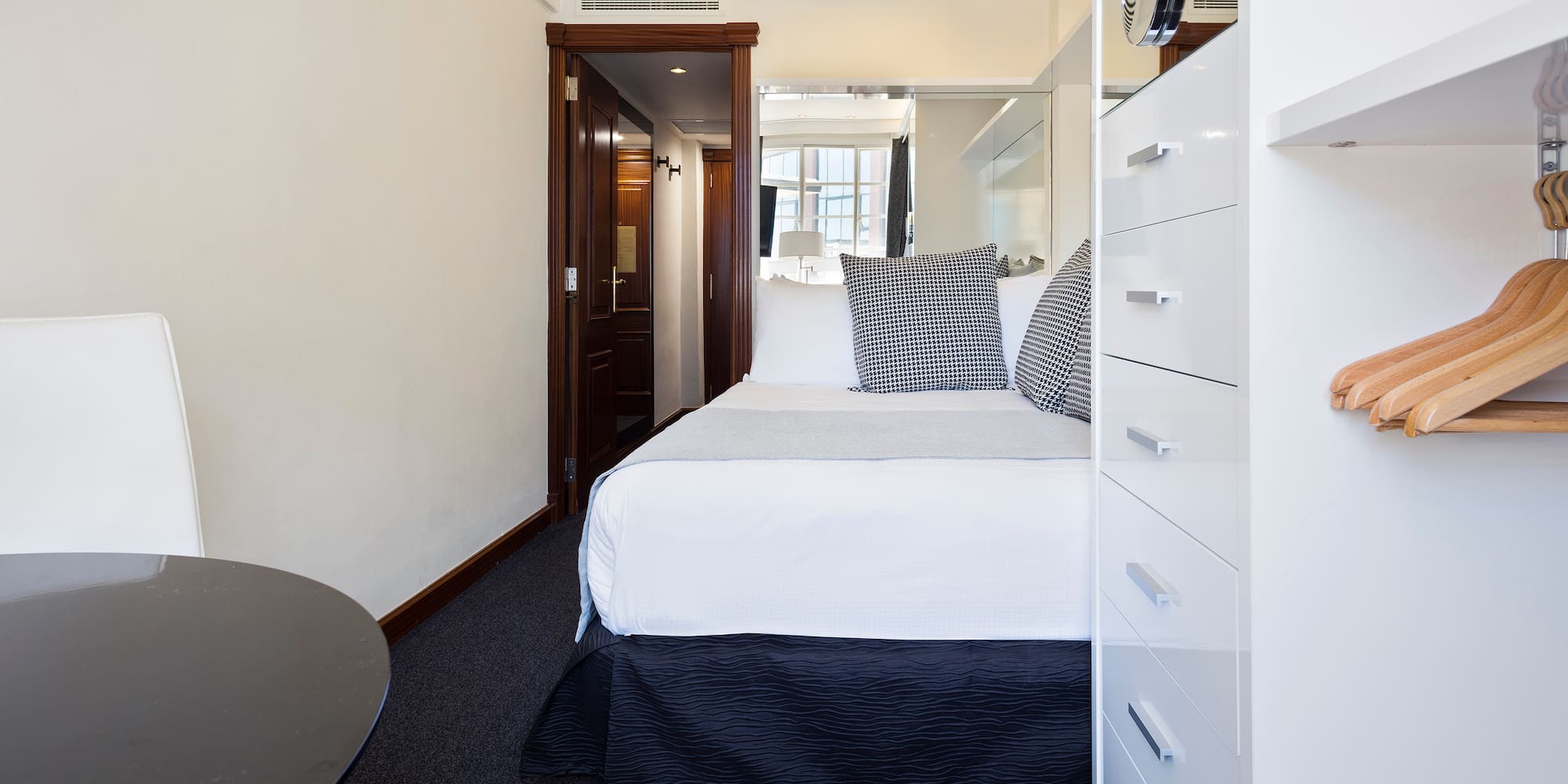 a bedroom with a bed and a mirror