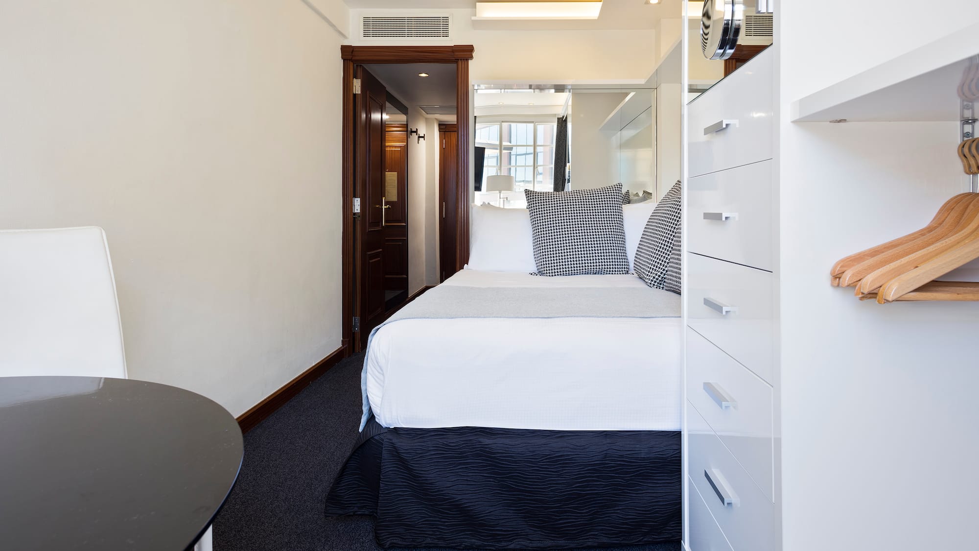 a bedroom with a bed and a mirror