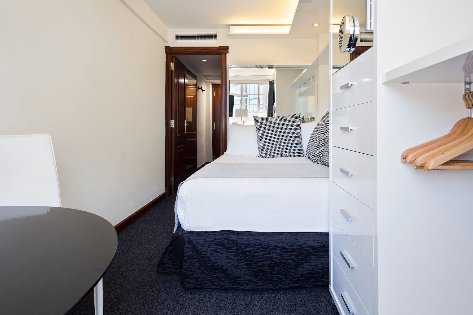 a bedroom with a bed and a mirror