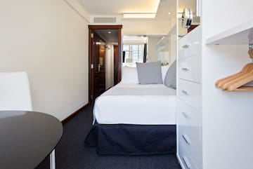 a bedroom with a bed and a mirror