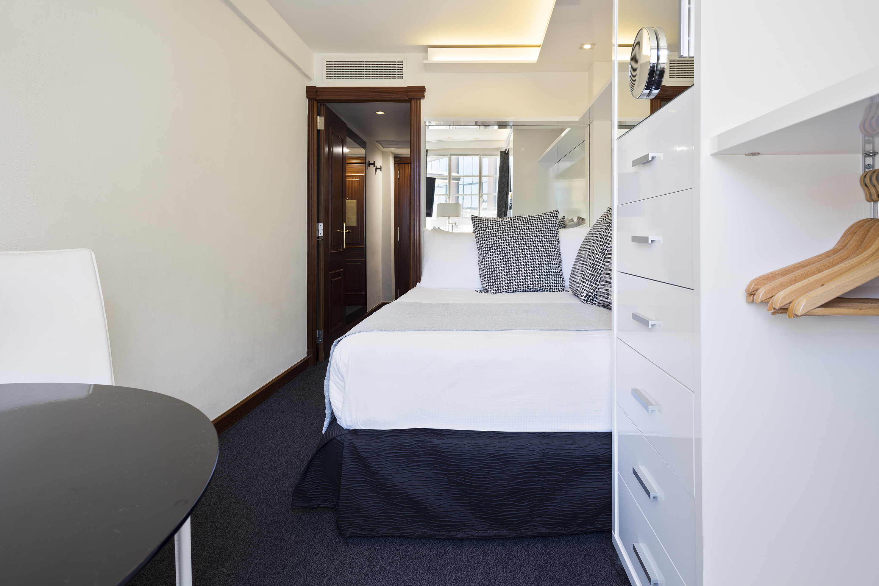 a bedroom with a bed and a mirror