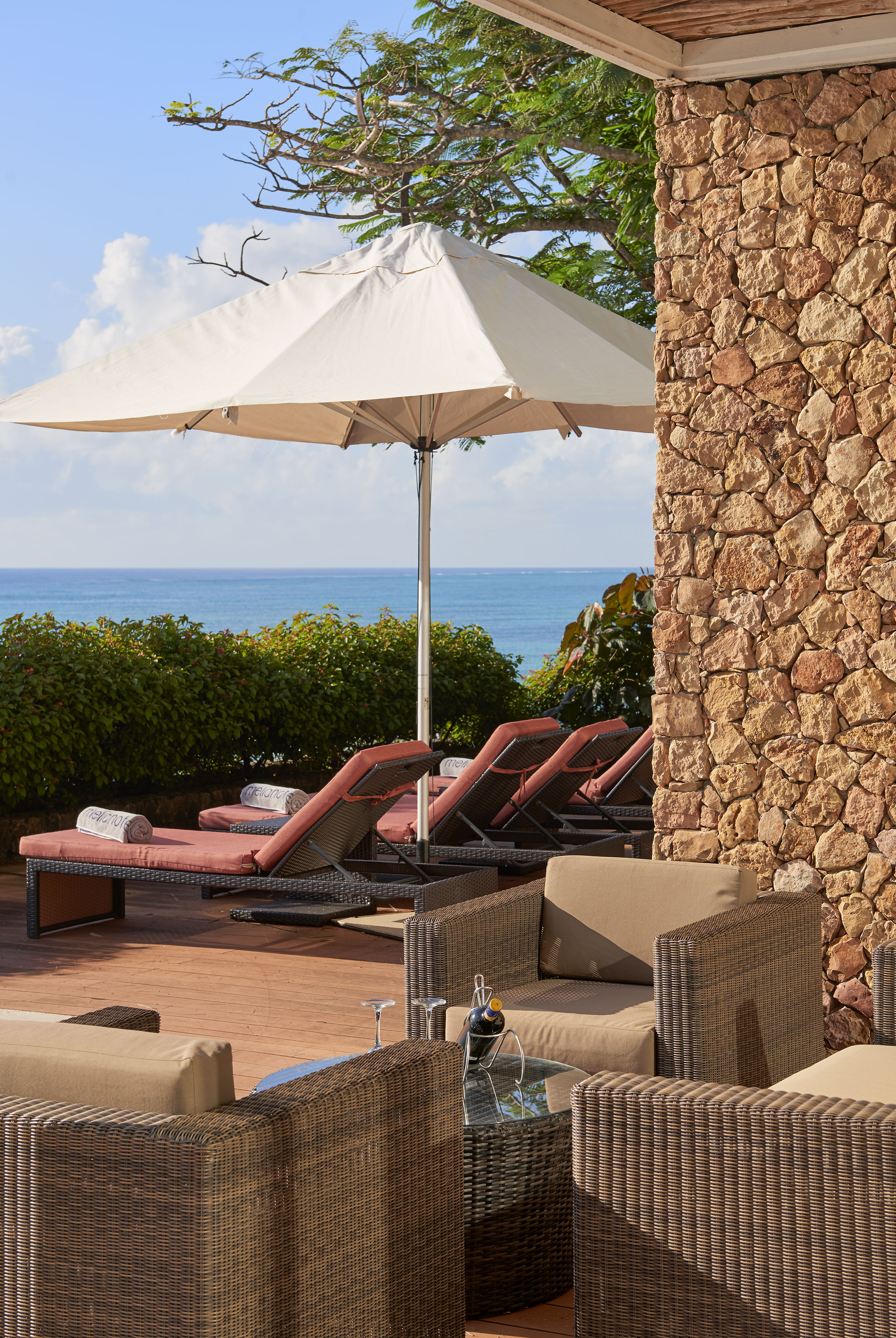 a patio with chairs and umbrella