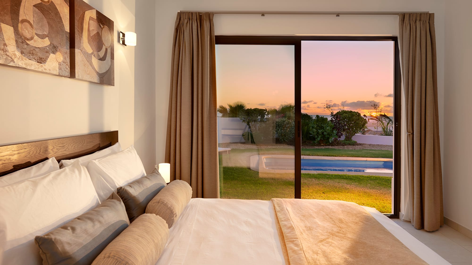a bed with a view of a pool outside