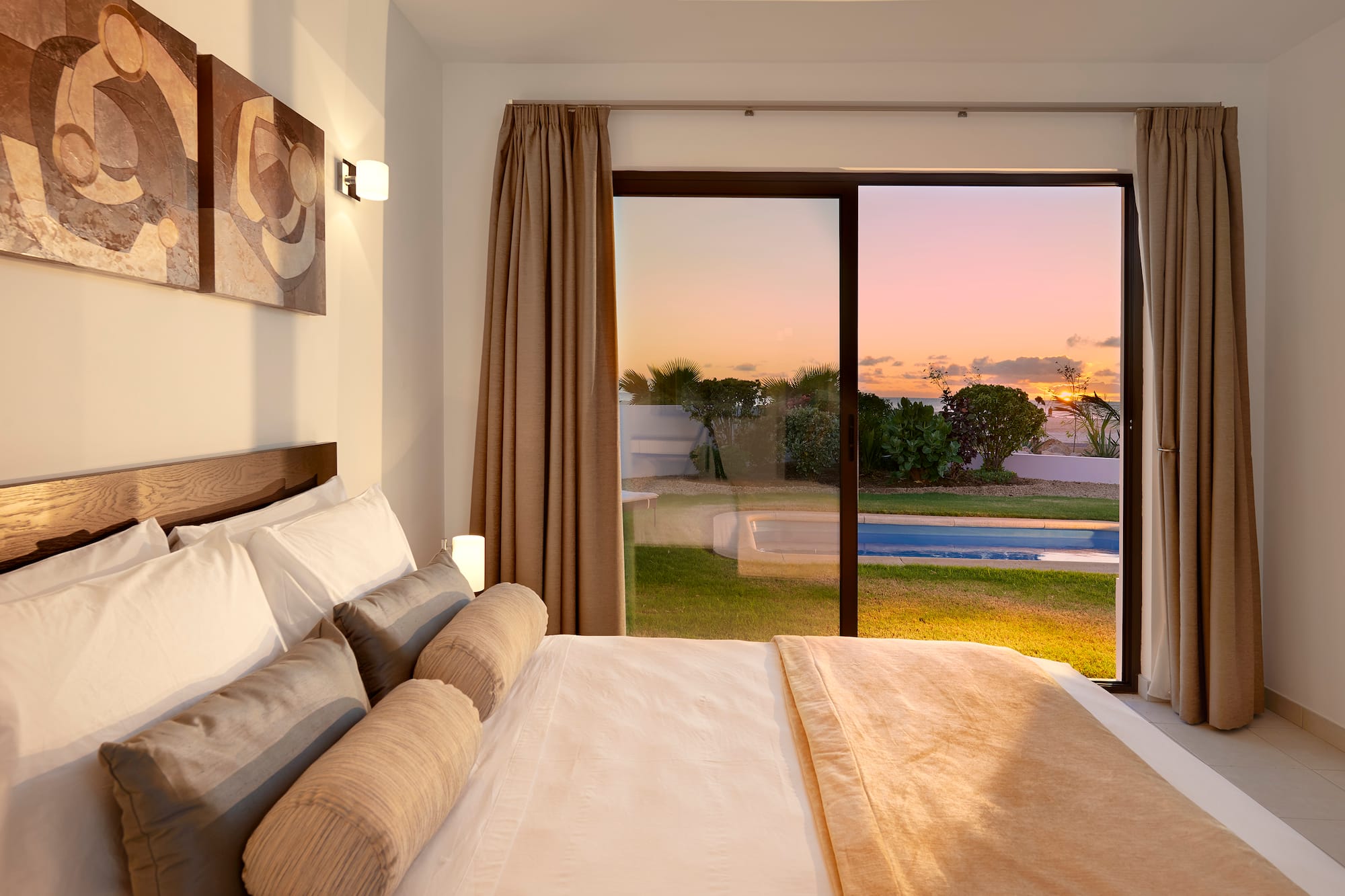 a bed with a view of a pool outside