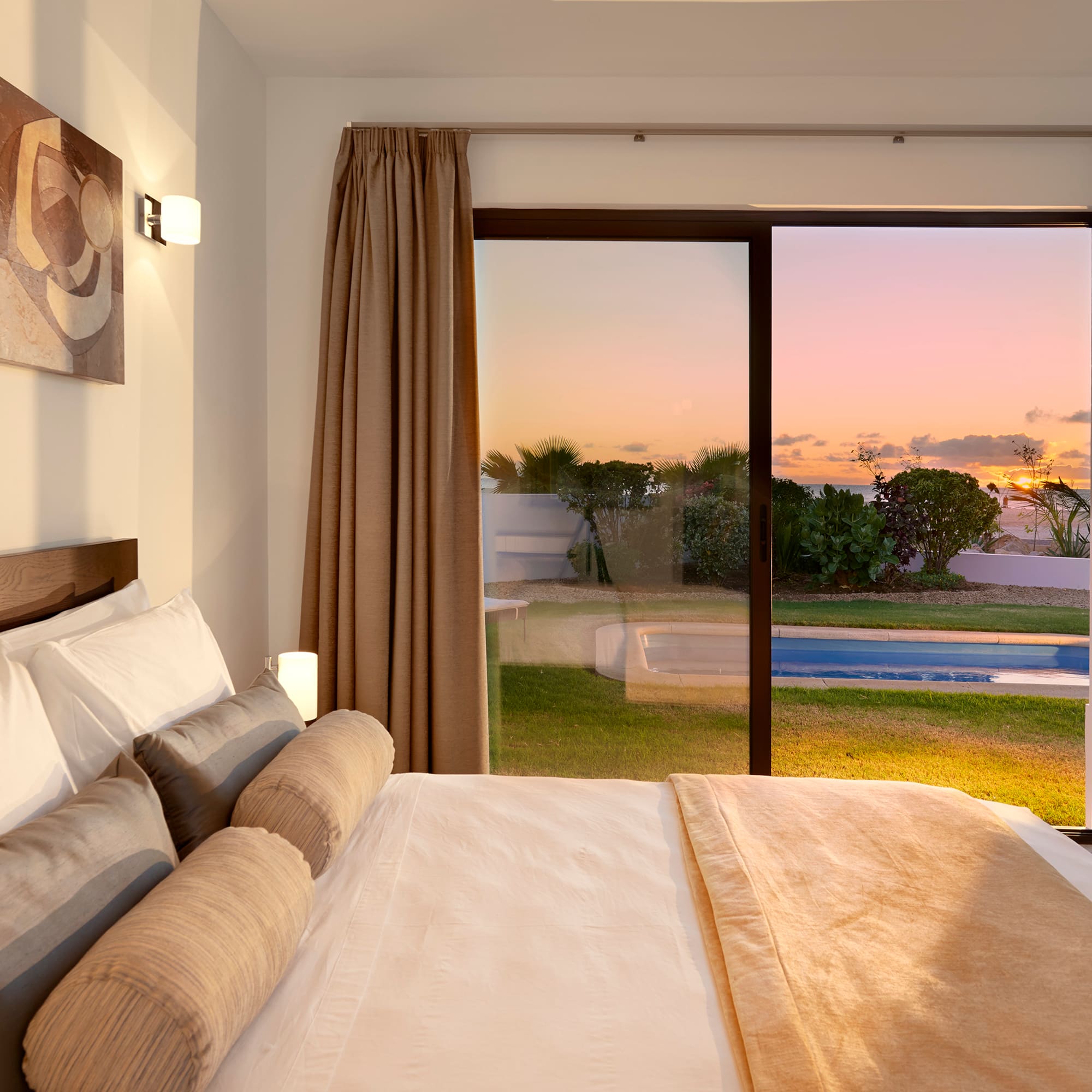a bed with a view of a pool outside
