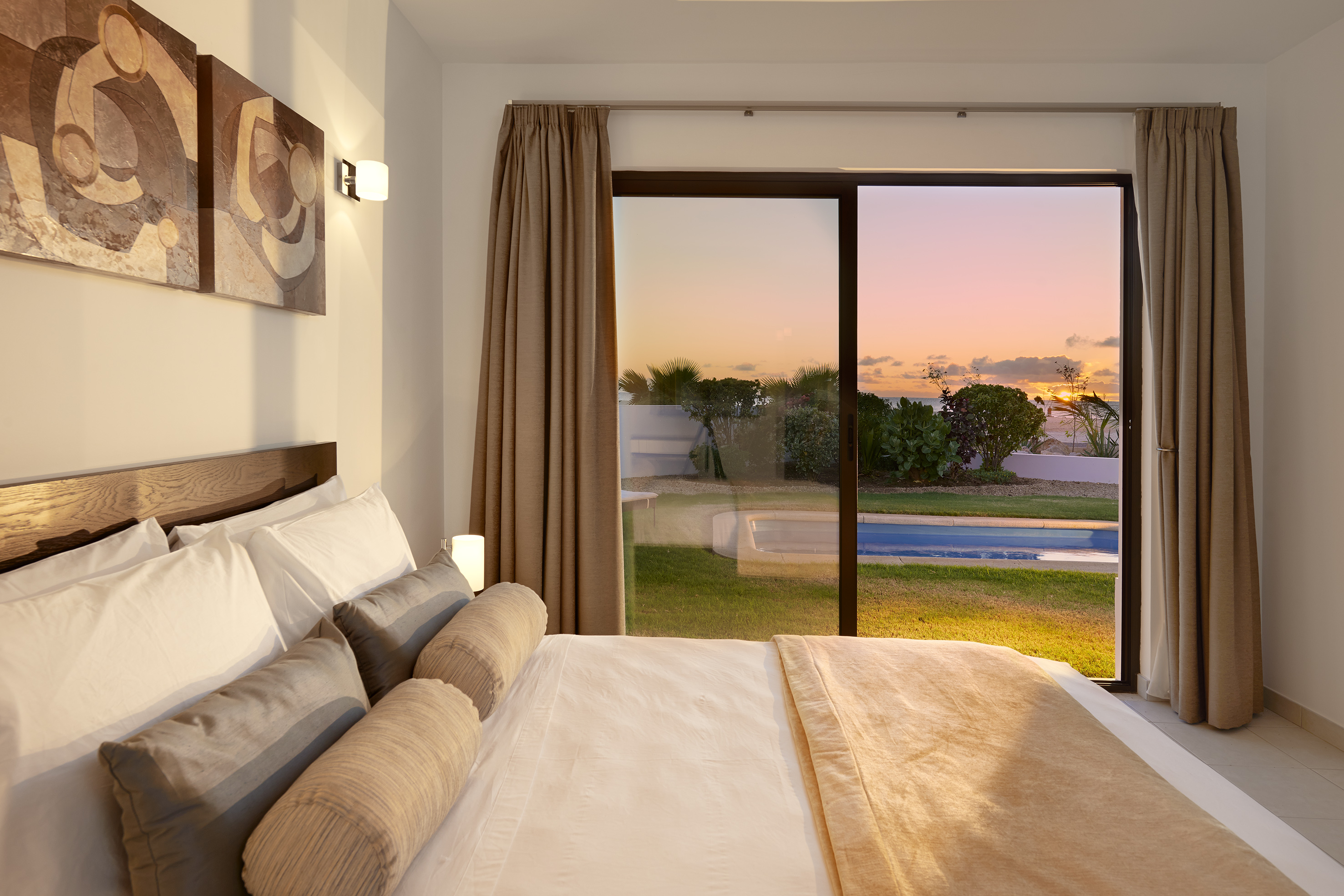 a bed with a view of a pool outside