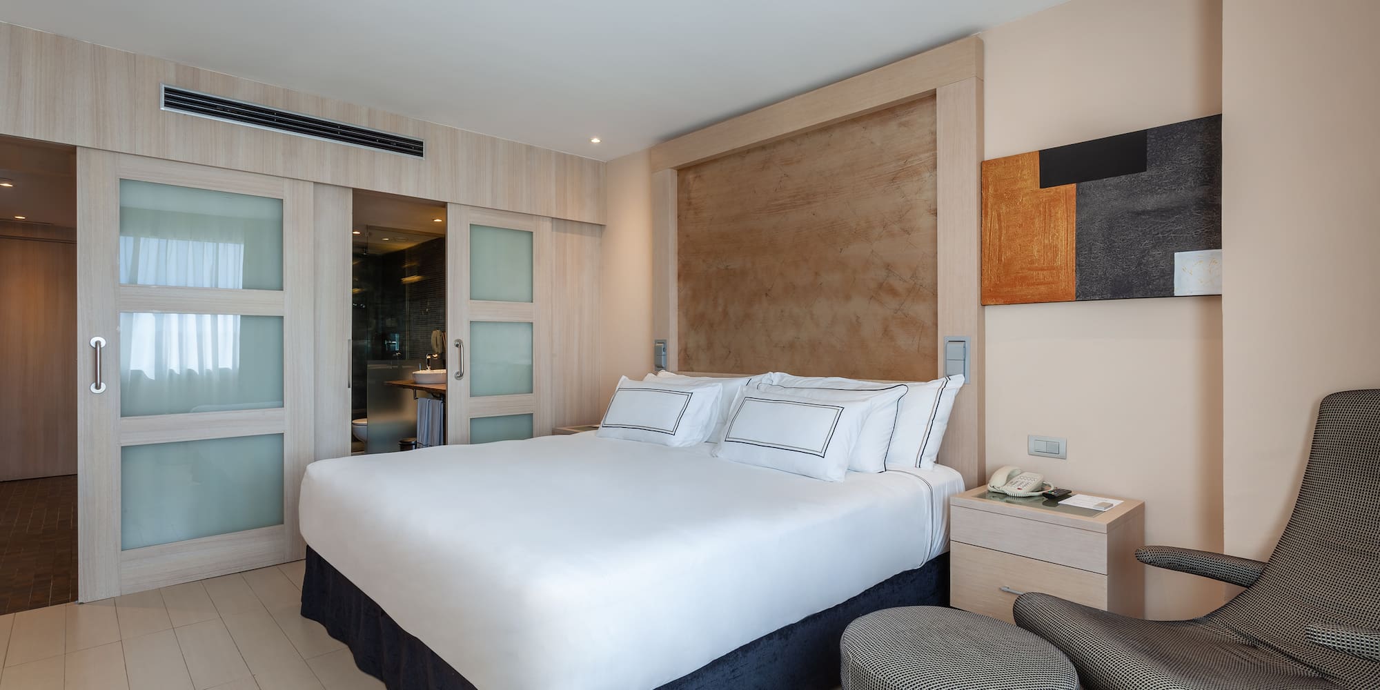 a bedroom with a bed and a chair