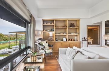 a living room with a large glass wall and a large window