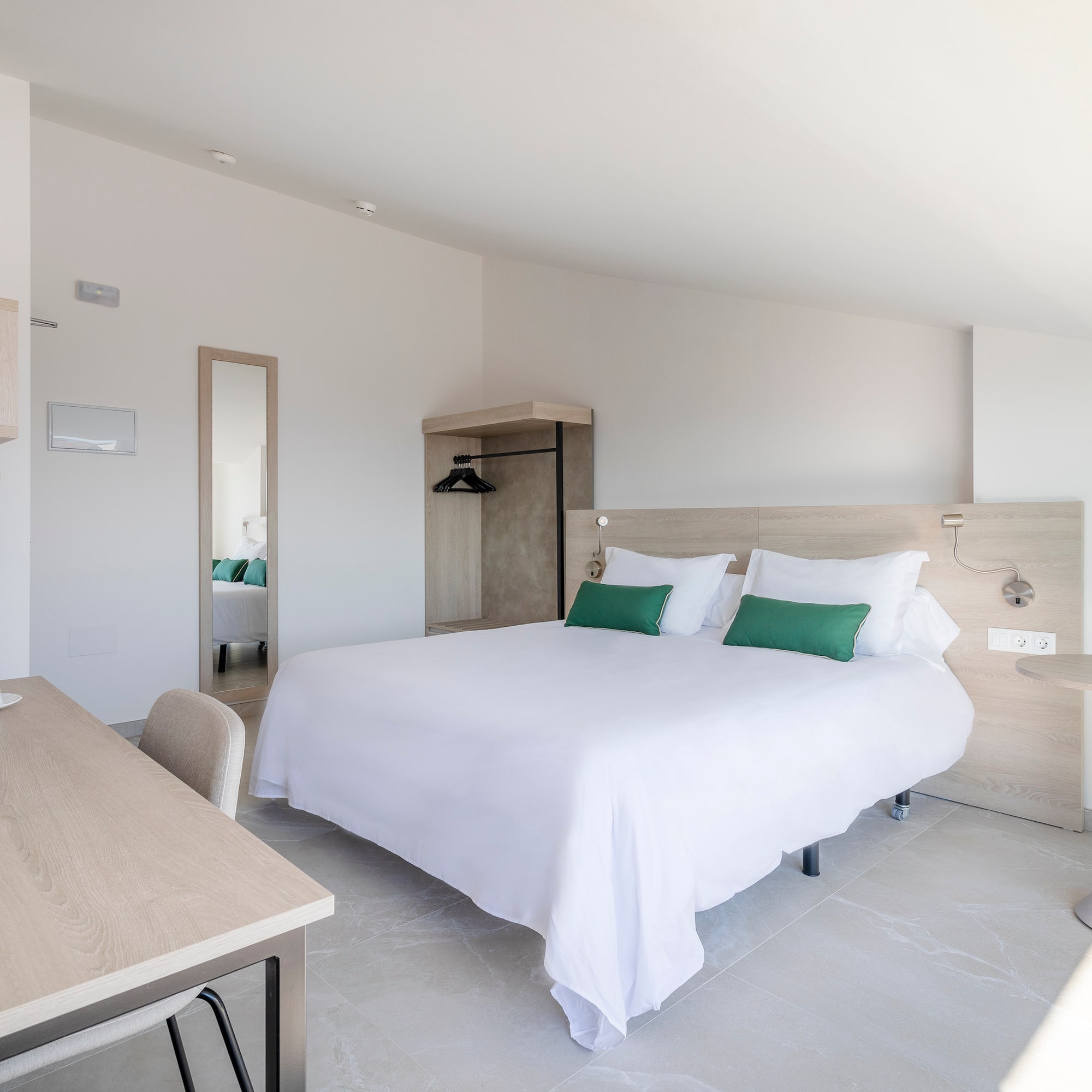 a bedroom with a bed and a desk