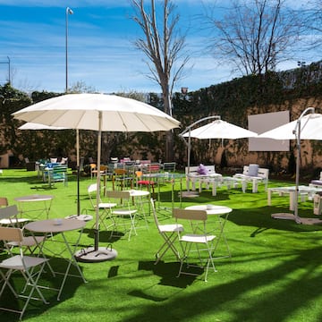a group of tables and chairs on a lawn