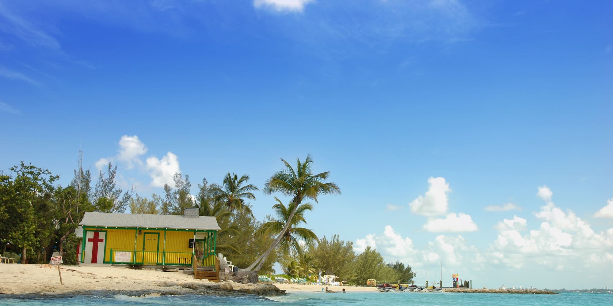 a yellow building on a beach