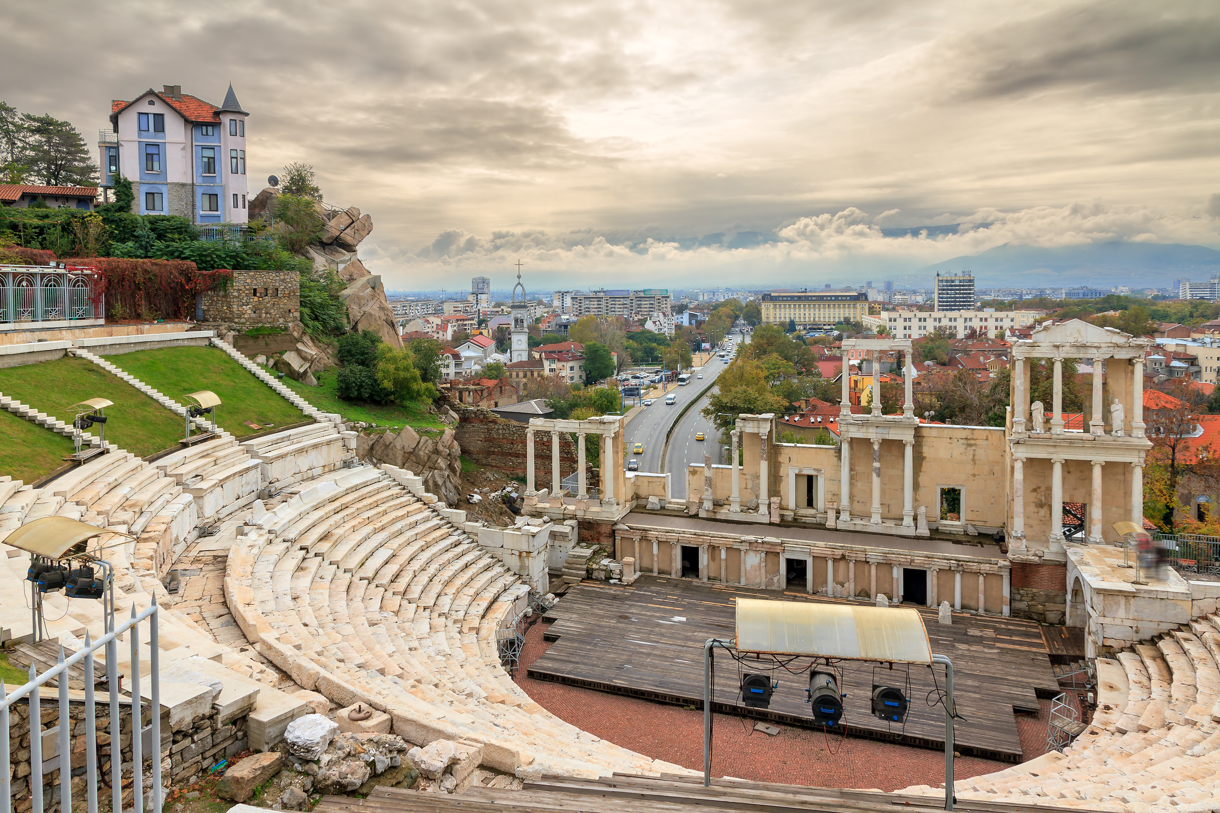 an old amphitheater with a city in the background