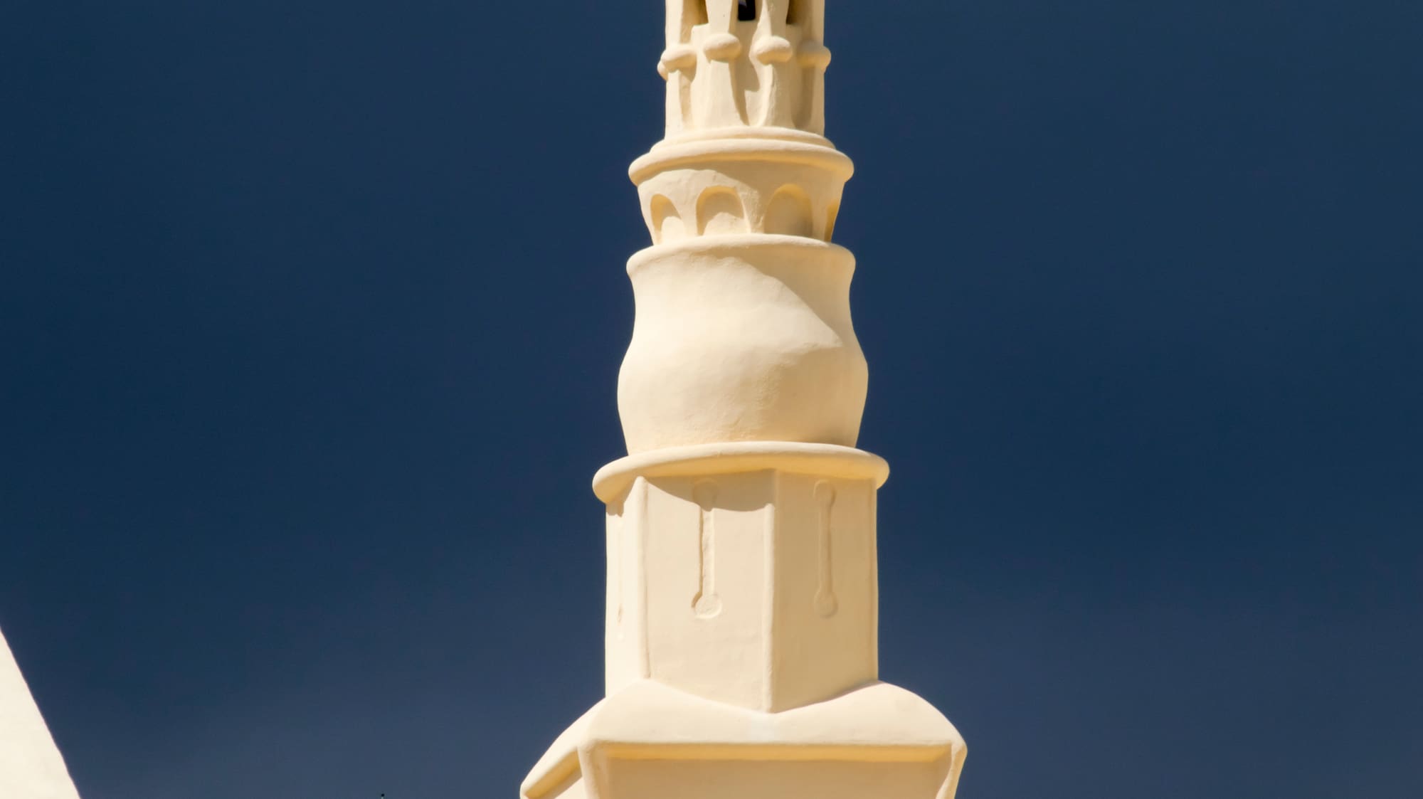 a white tower with a pointy top