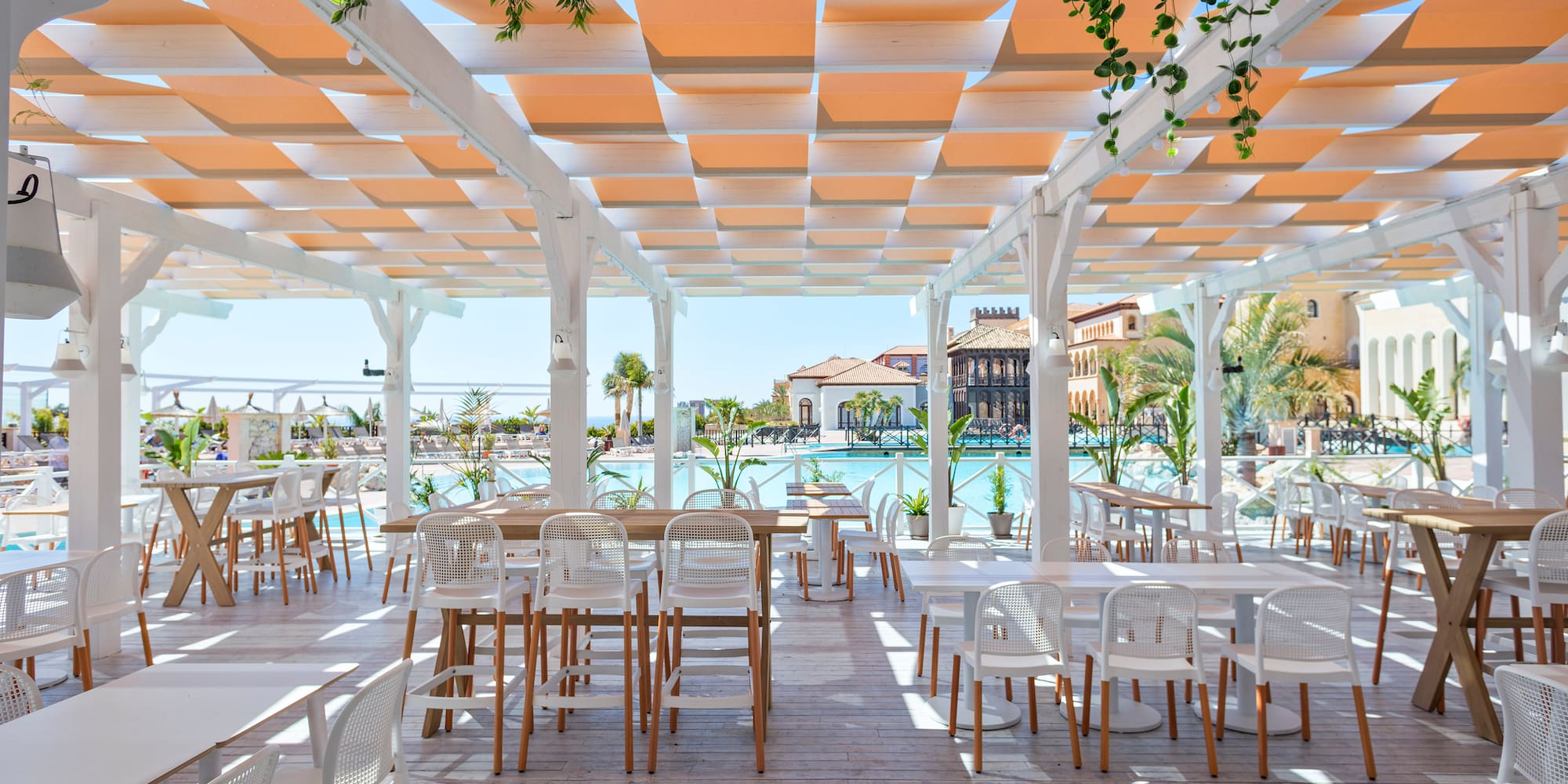 a white patio with tables and chairs