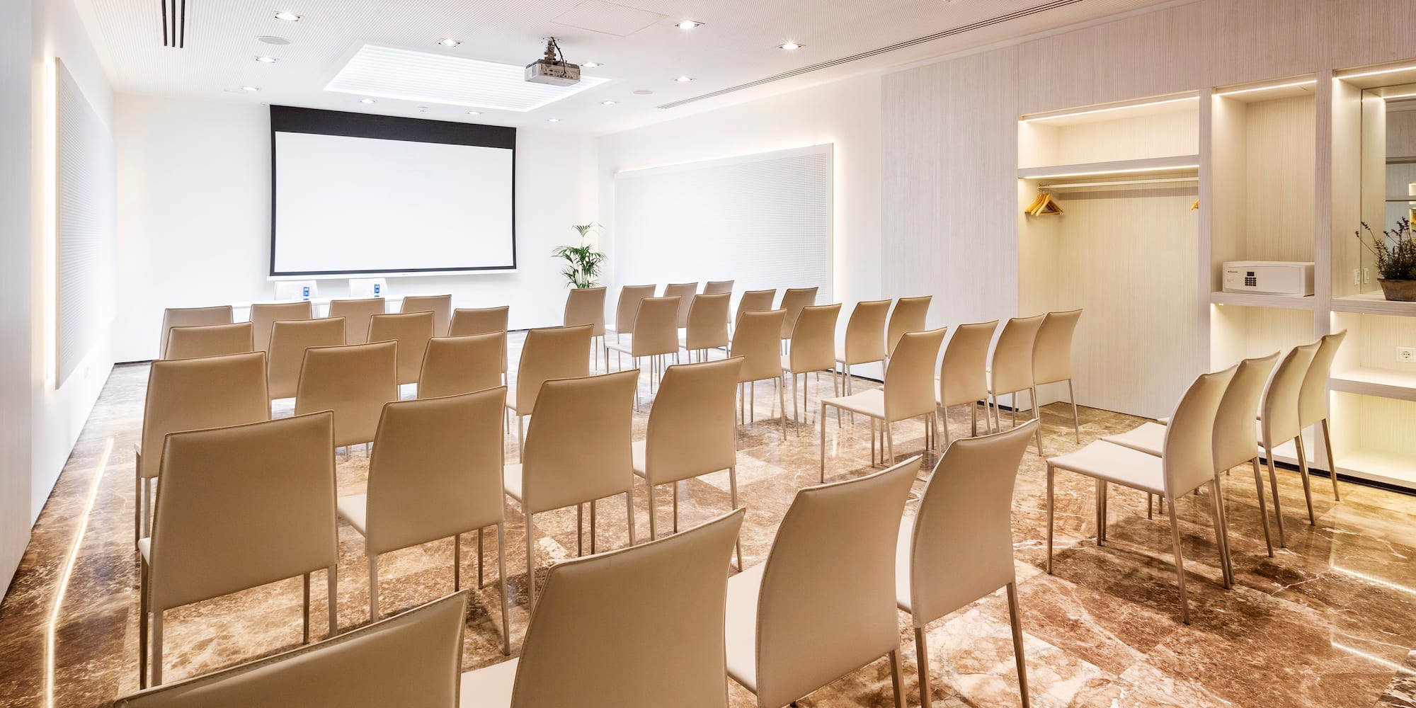 a room with chairs and a projector screen
