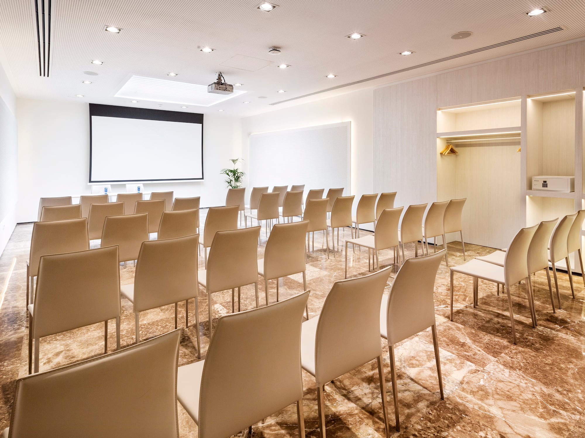 a room with chairs and a projector screen