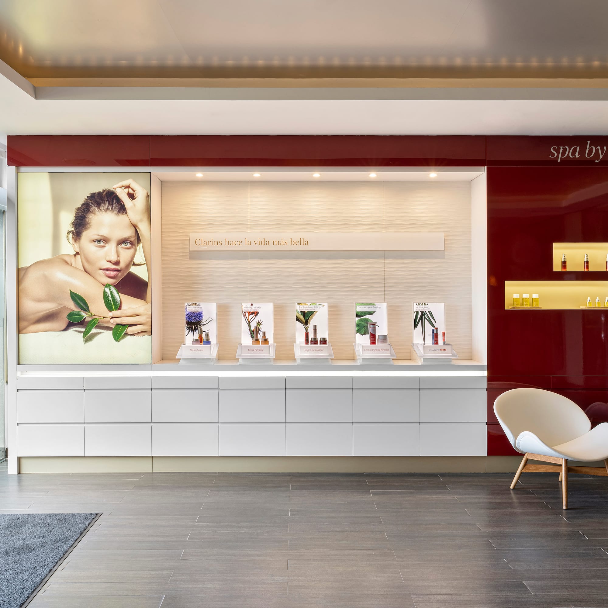 a room with a white chair and a poster on the wall