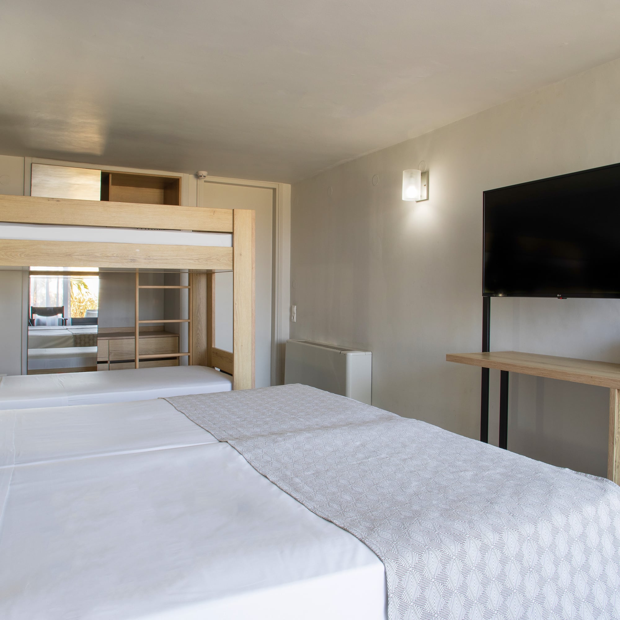 a room with a tv and a bed