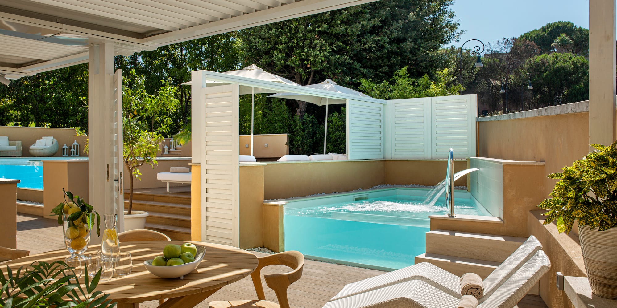 a patio with a pool and chairs