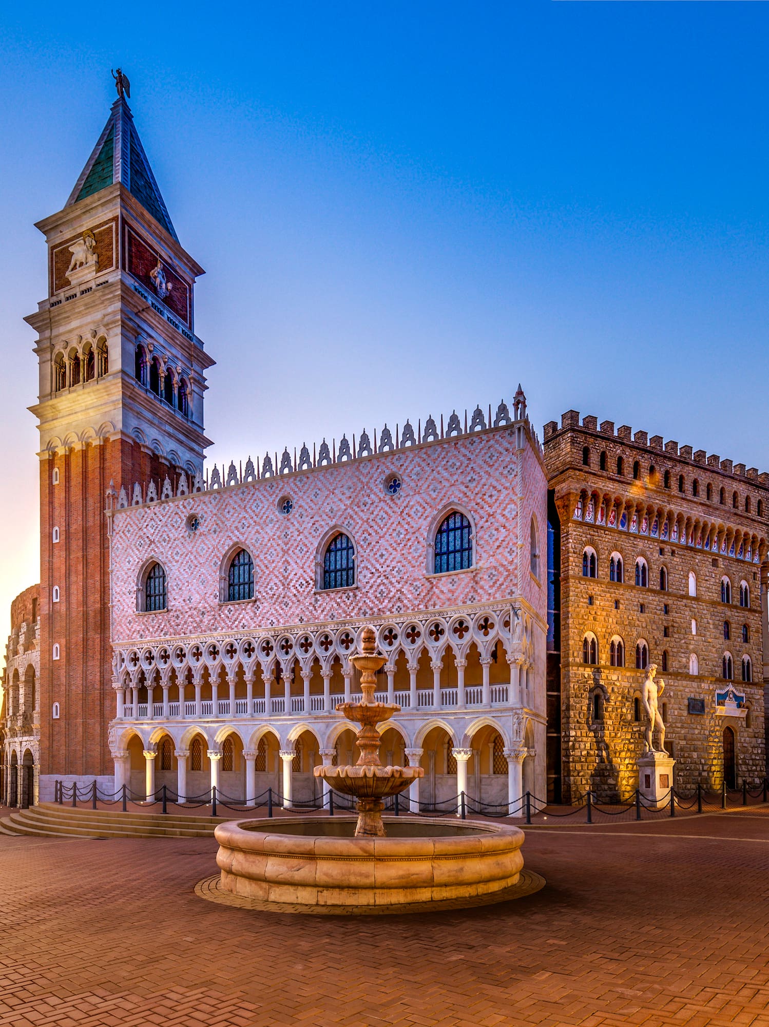 a building with a clock tower and a fountain in front of it