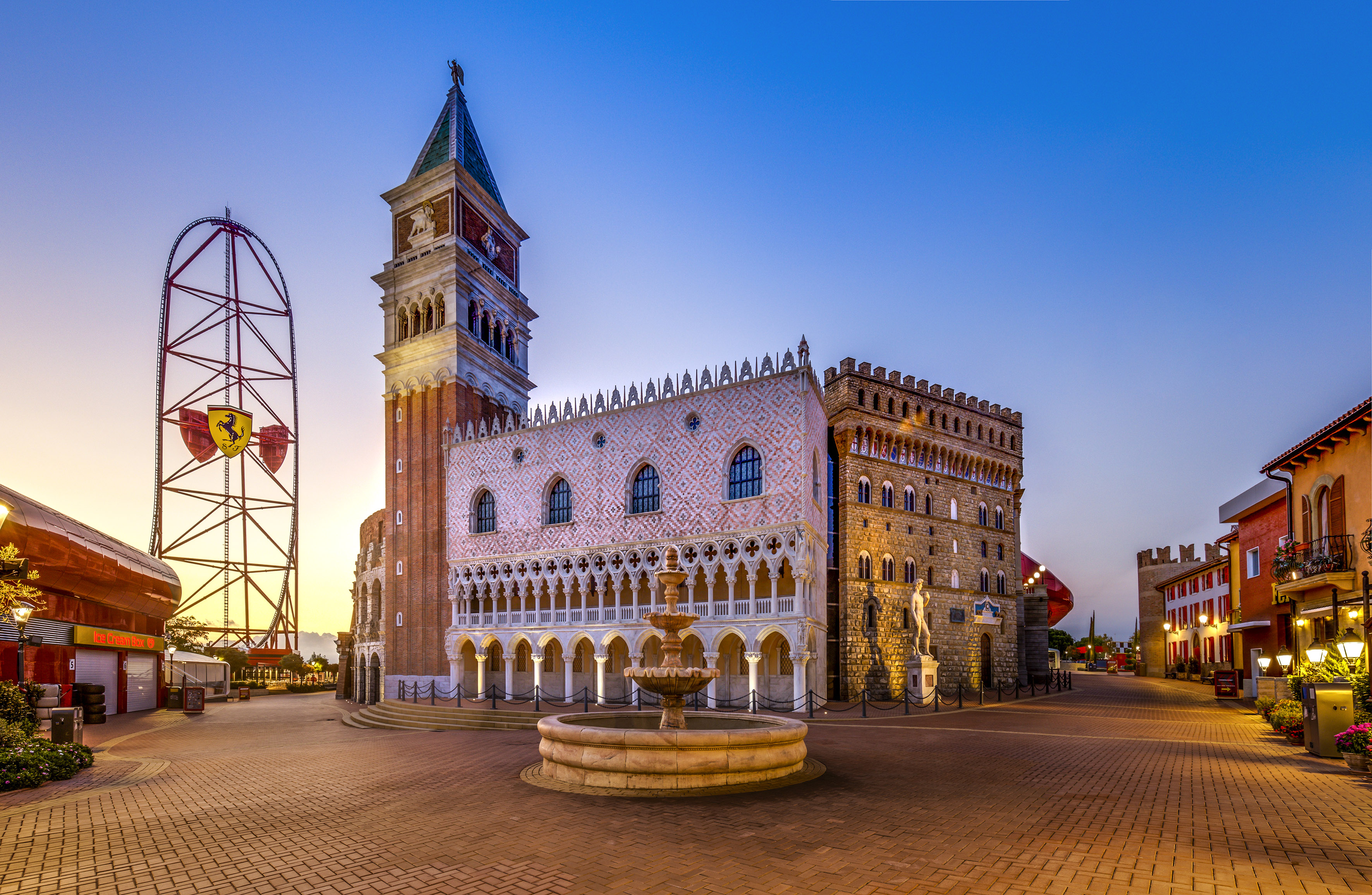 a building with a clock tower and a fountain in front of it