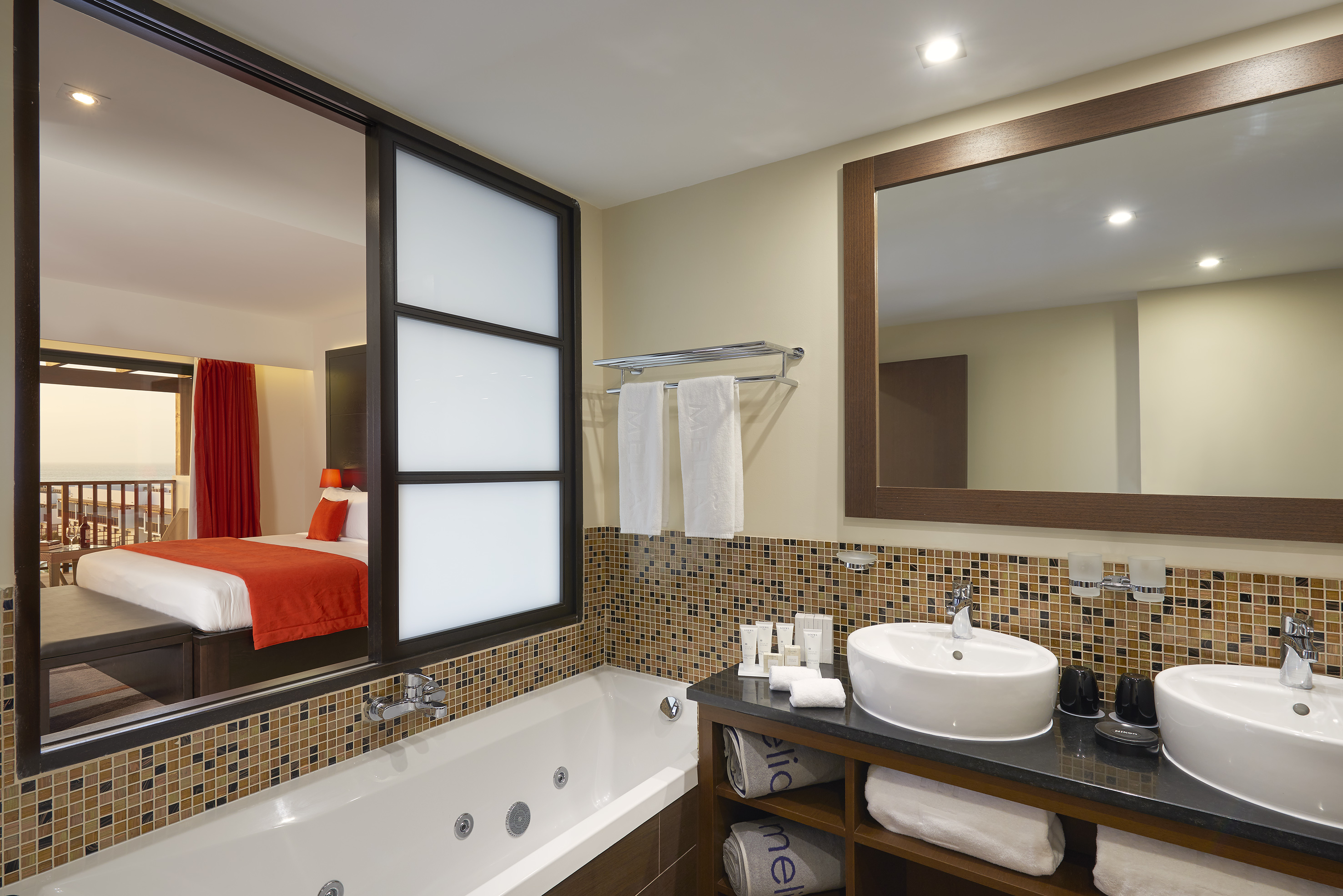 a bathroom with a bathtub and a mirror