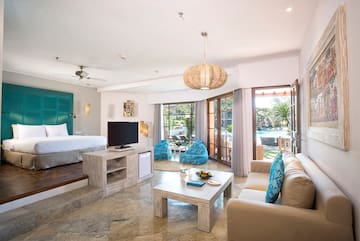a room with a bed and a television