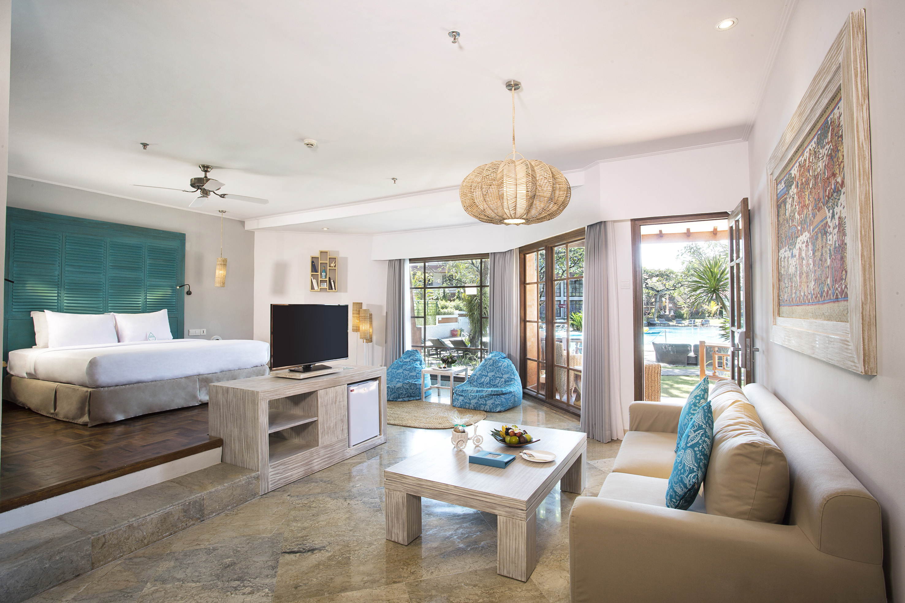 a room with a bed and a television