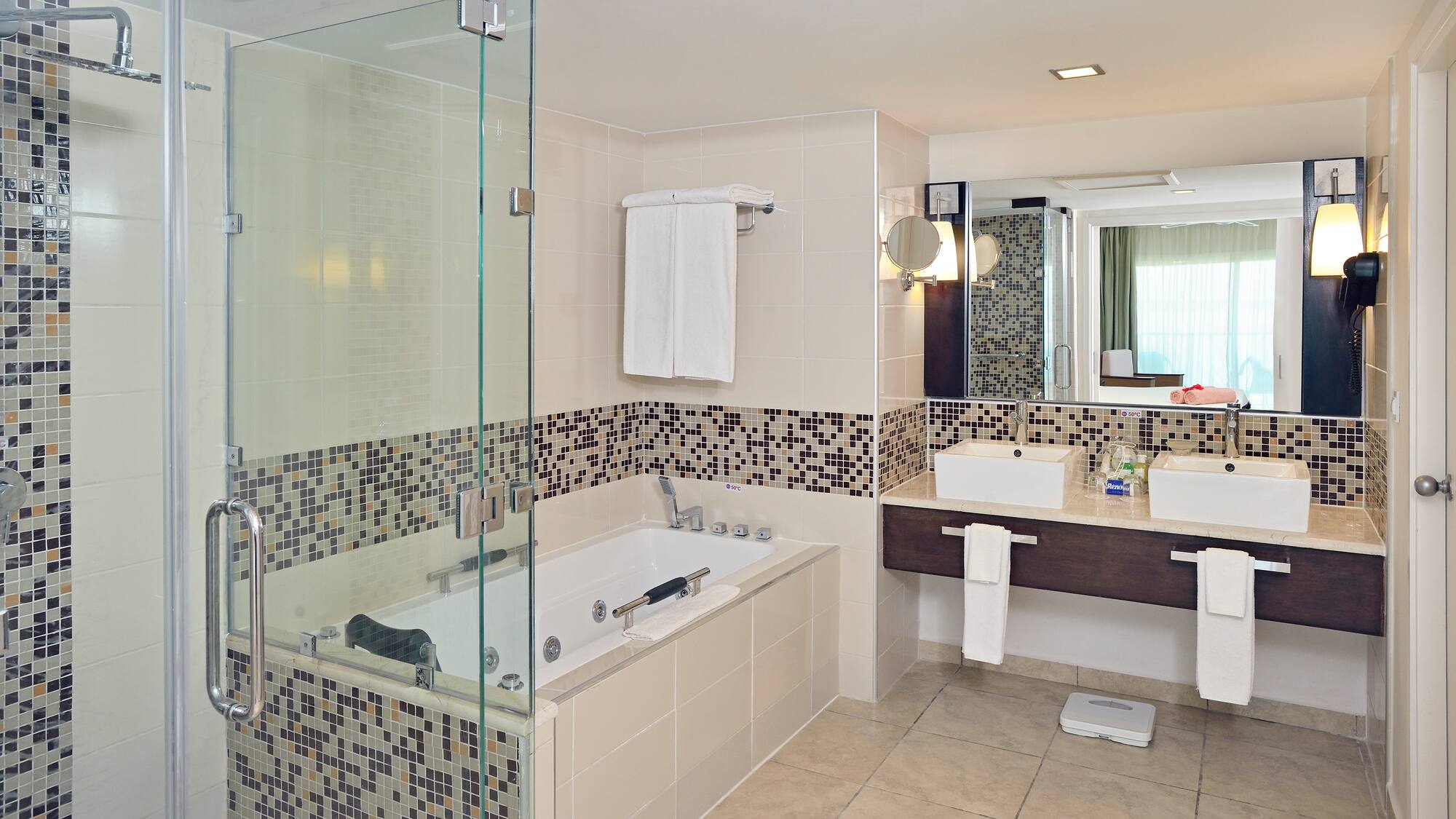 a bathroom with a glass shower and bathtub