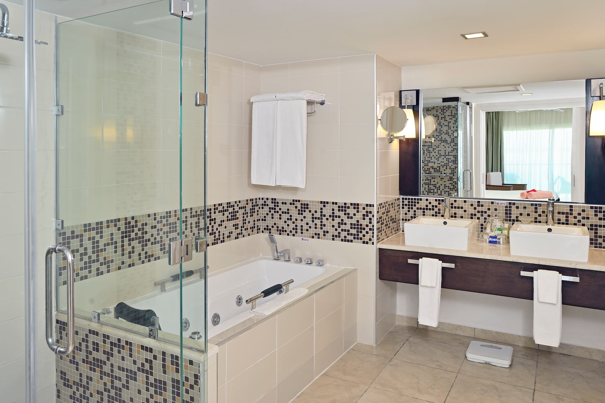 a bathroom with a glass shower and bathtub