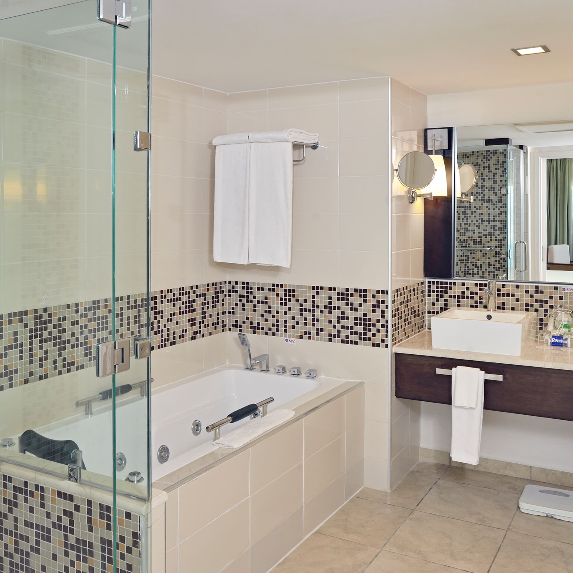 a bathroom with a glass shower and bathtub