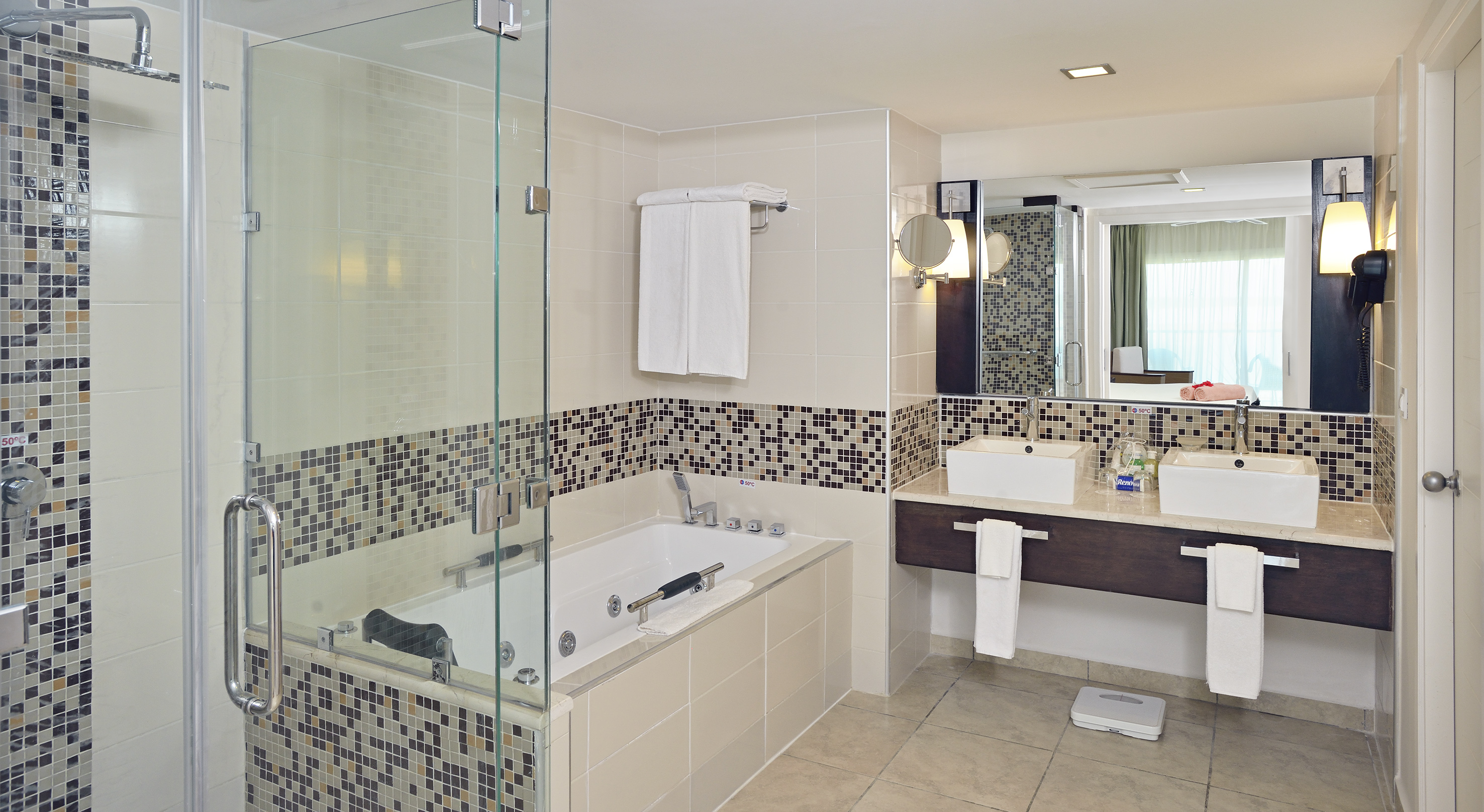 a bathroom with a glass shower and bathtub