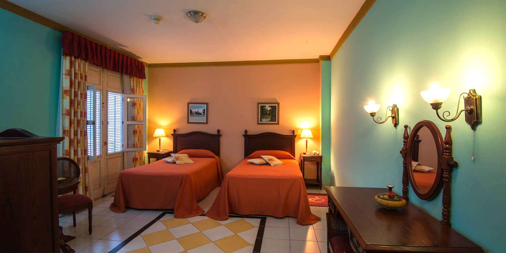 a room with two beds and a mirror